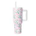 White insulated tumbler with handle and lid featuring pink flowers and green foliage pattern, Simple Modern logo, against white background.